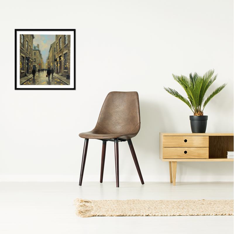 Old Montreal framed art print, impressionist historic street scene with grey architectural tones, 310 gsm matte art paper in a black box frame. Hung on a wall near a brown chair and table.