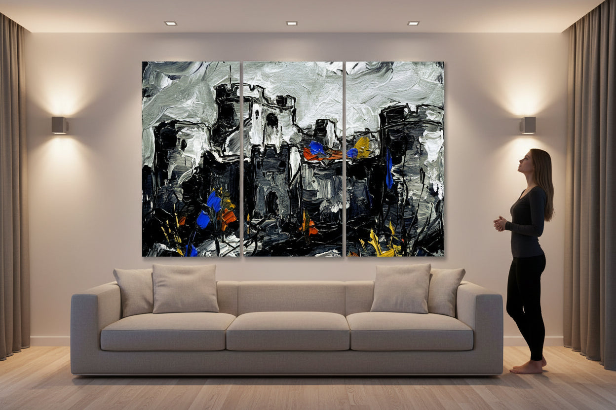 A Large Acrylic style Triptych of a Castle adorns a wall over a couch in a large room while the owner studies it.
